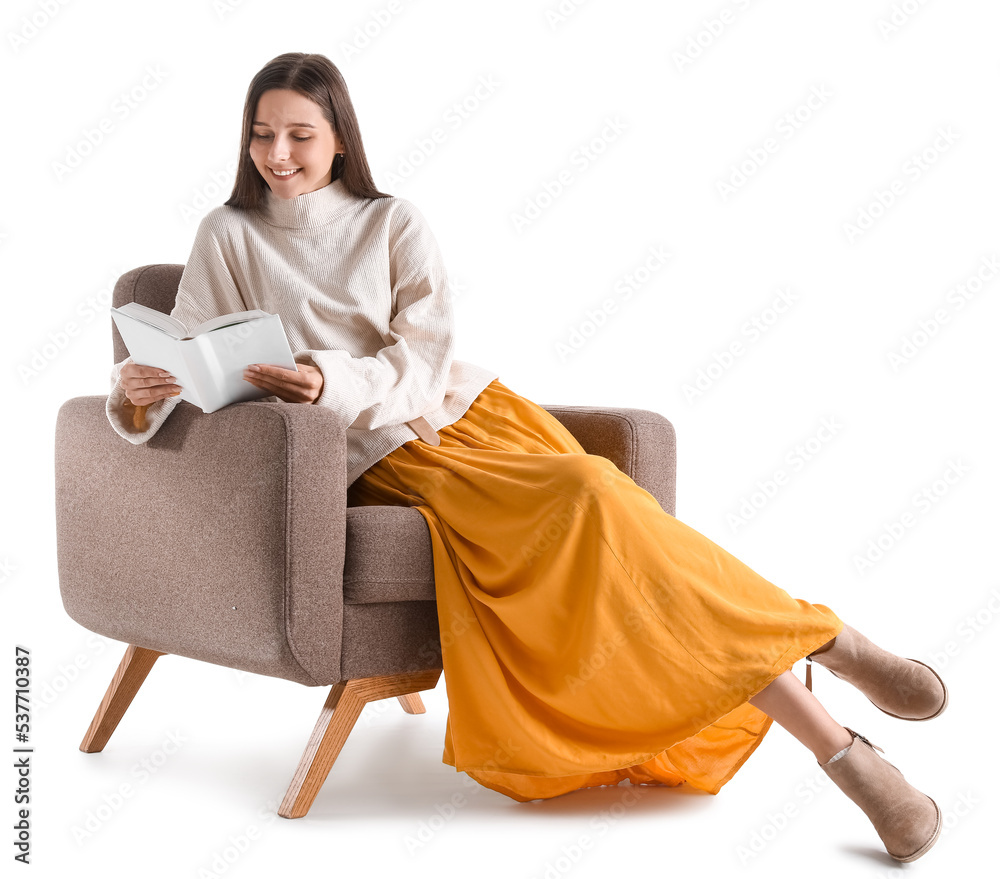 Beautiful woman reading book in armchair on white background