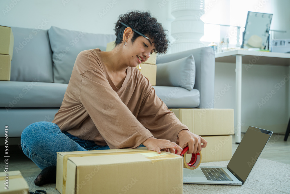 Owners female entrepreneurs writing address on parcel for delivery to customer,Shipping and logistic