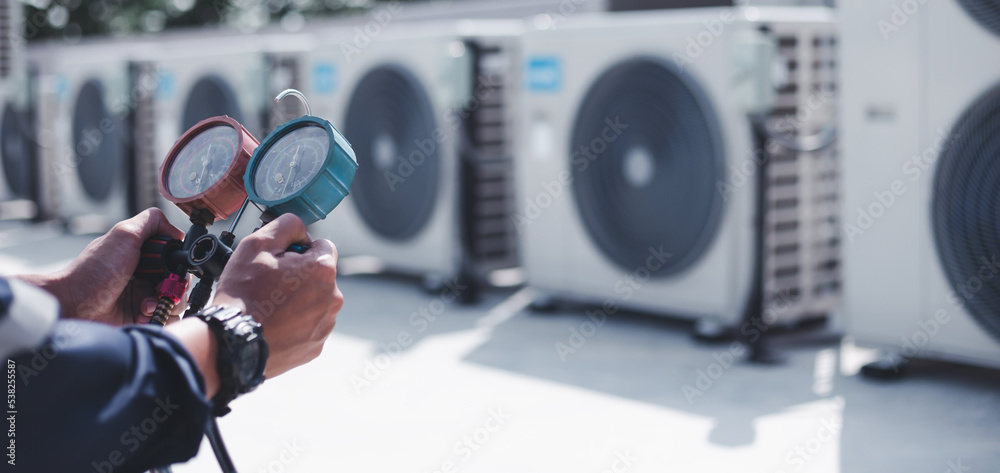 Technician is checking air conditioner ,measuring equipment for filling air conditioners.