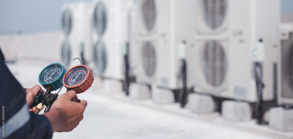 Technician is checking air conditioner ,measuring equipment for filling air conditioners.