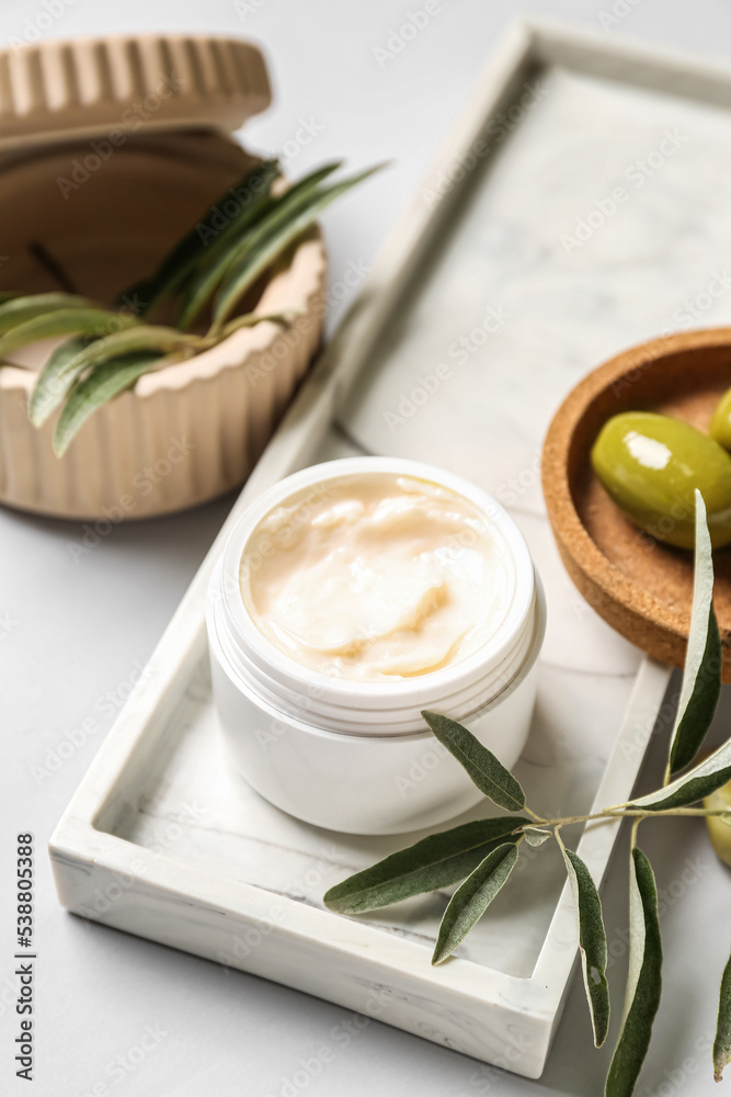 Jar of natural olive cream on white background, closeup