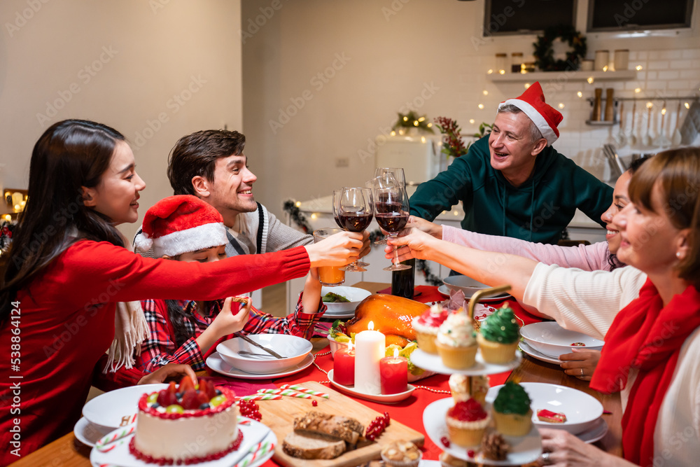 Multi-ethnic big family celebrating Christmas party together in house.