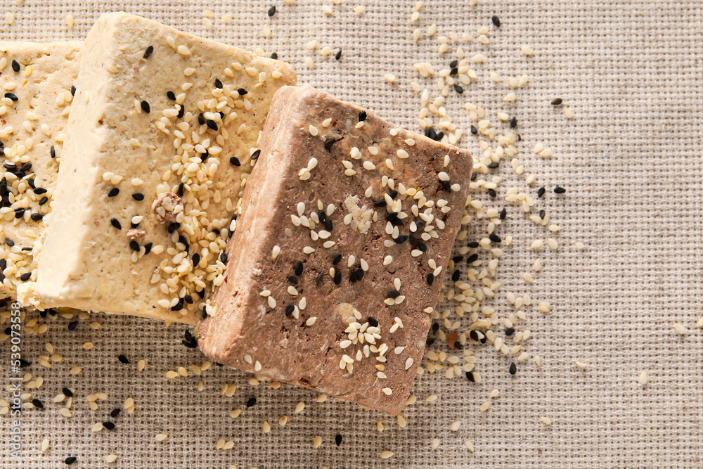 Tasty sesame halva on fabric background, closeup