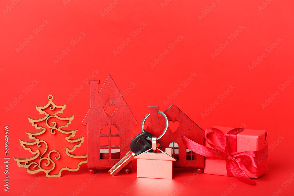 House figures with key, Christmas gift and decor on red background