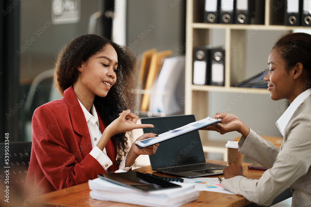 two women discussing business plans in the office