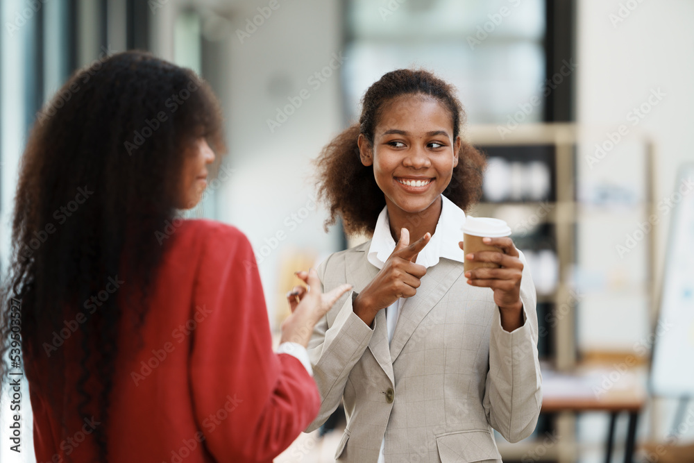 two women discussing business plans in the office