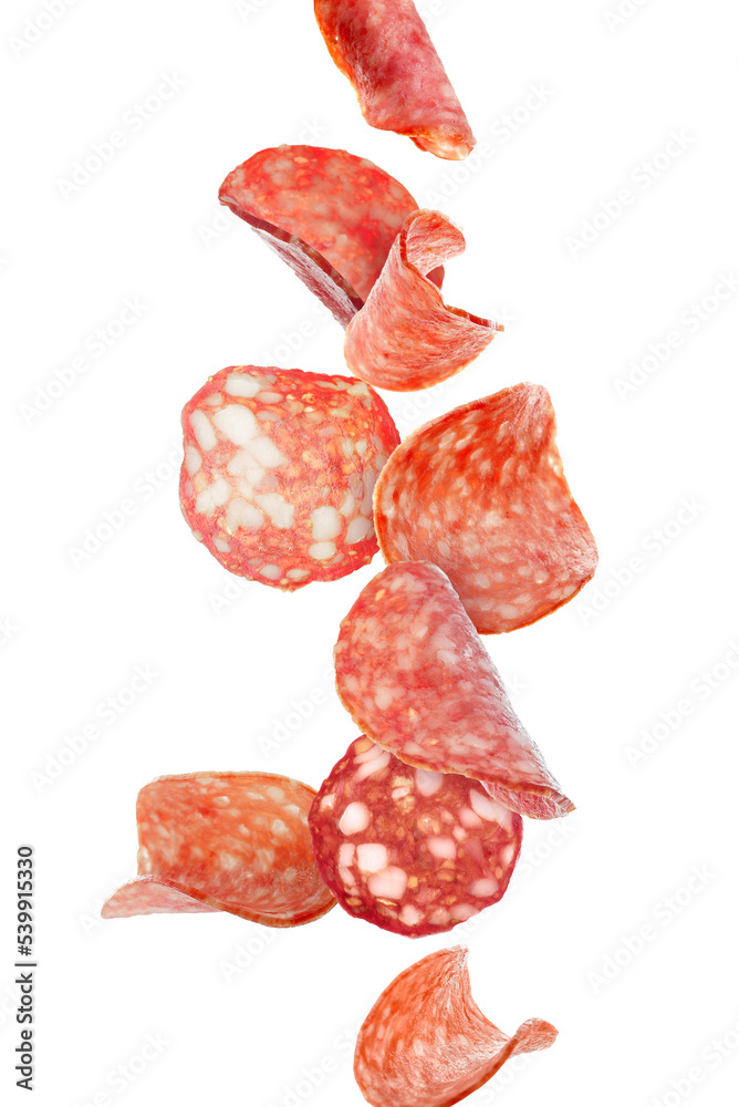 Flying slices of delicious salami isolated on white