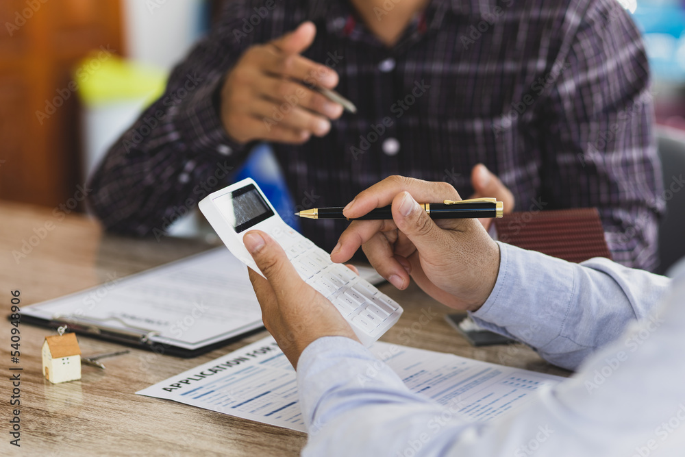 Real estate agents discuss home and land purchases with customers after agreeing to a home purchase 