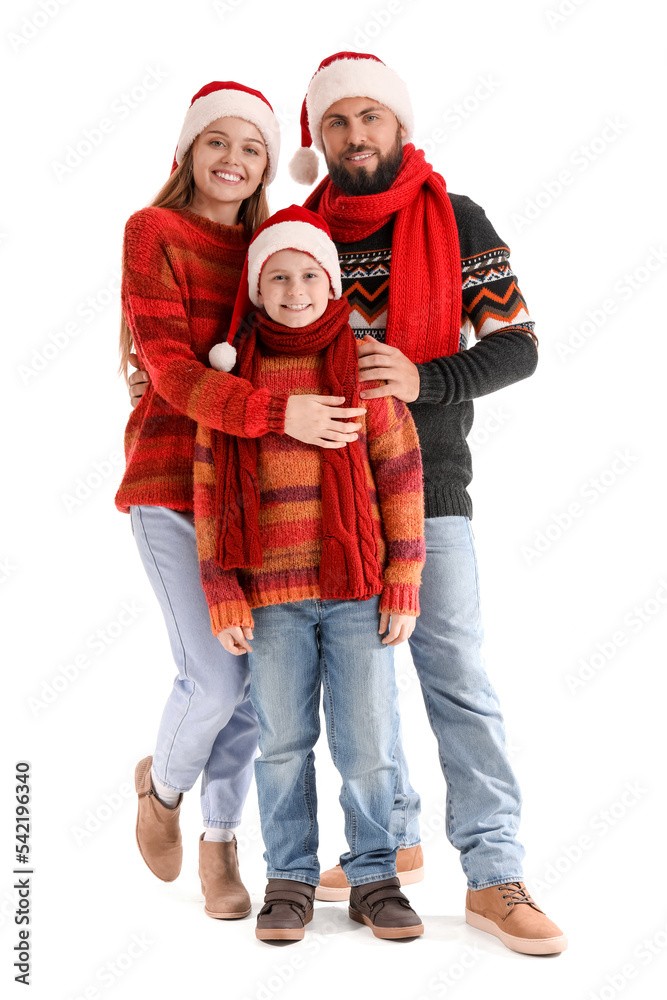 Happy parents with their little son in Santa hats and warm clothes on white background