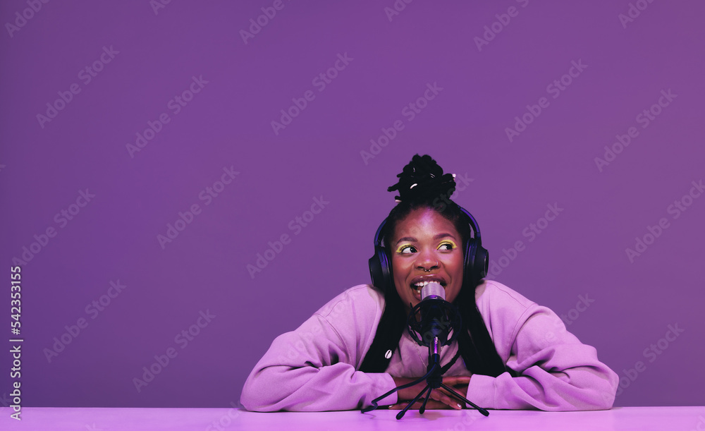 Female podcaster speaking into a microphone