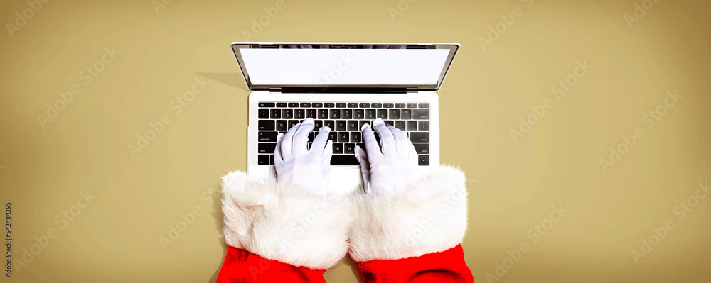 Santa Claus using a laptop computer from above