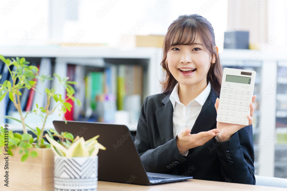 オフィスで電卓を持つ女性