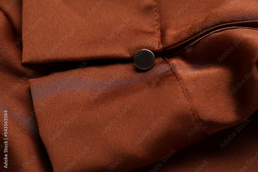 Closeup view of silk sleeve with button