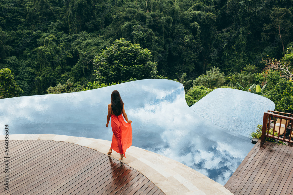 Woman walking near poolside of holiday resort