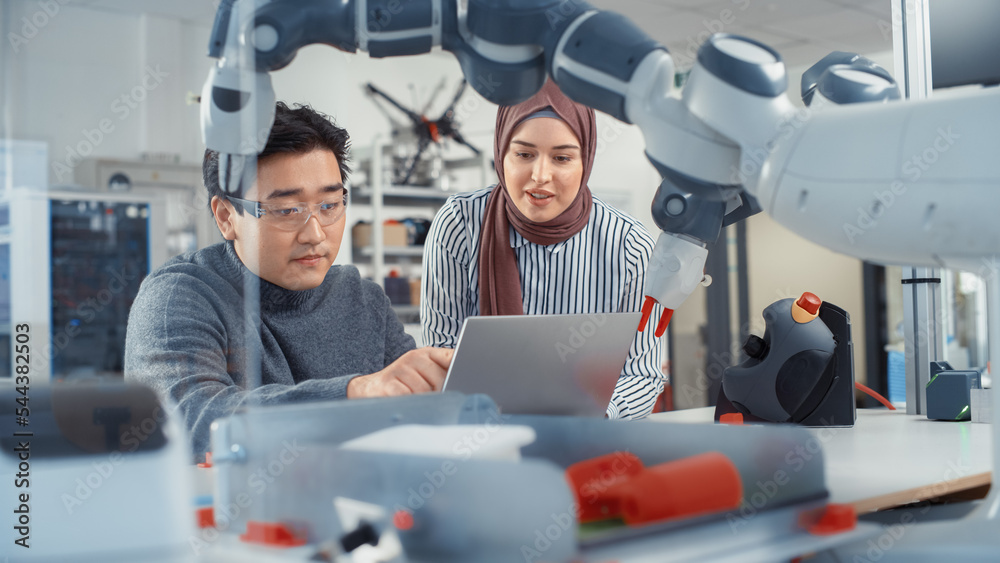 In Technology Research Facility: Young Female Specialist Talks With Asian Engineer. They Have A Disc