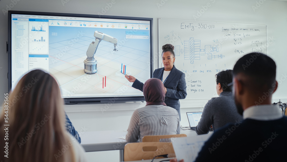 Female Professor Standing Next to Interactive Whiteboard and Teaching Diverse Students Innovations i