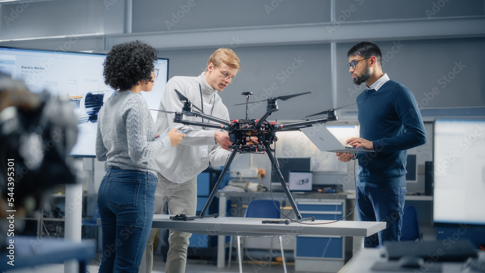 Diverse and Intelligent Science Specialists Looking at Prototype of the Drone and Talking About It i