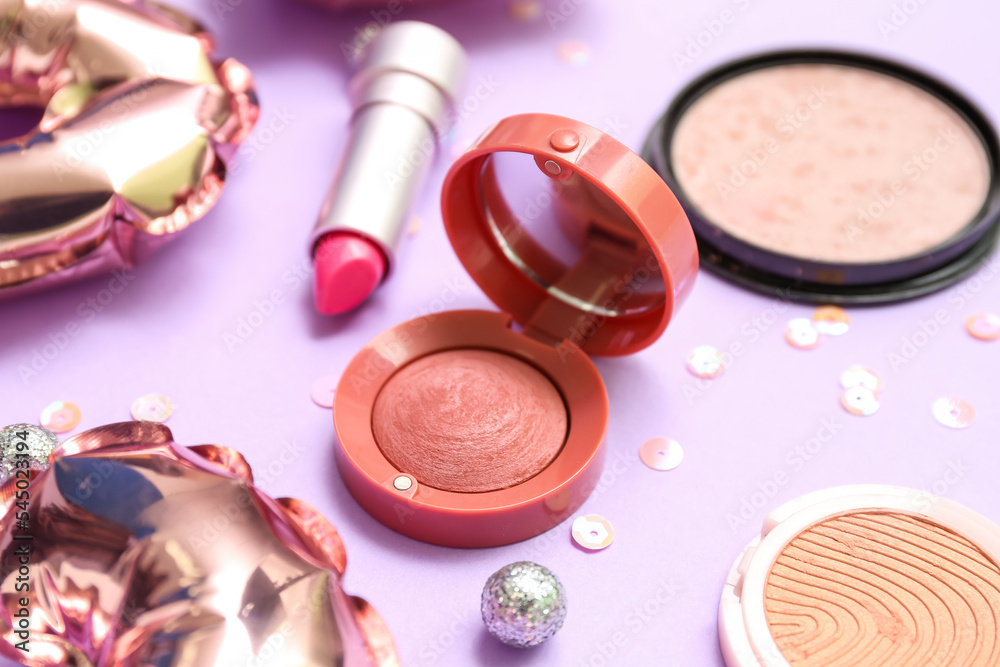 Makeup products with sequins on pink background, closeup