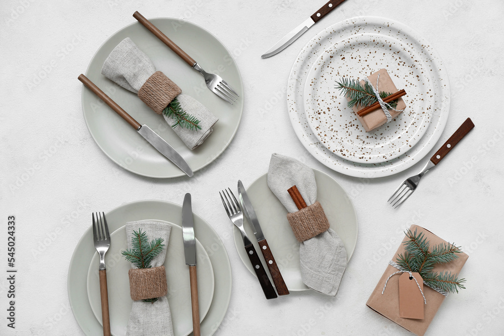 Christmas table setting with fir branches and cinnamon on white background