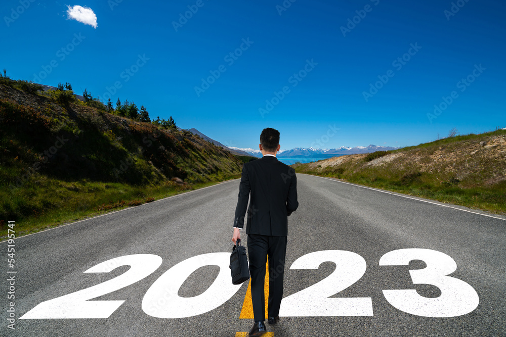 The 2023 New Year journey and future vision concept . Businessman traveling on highway road leading 