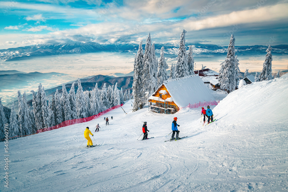 Skiers on the picturesque ski slope, Carpathians, Romania