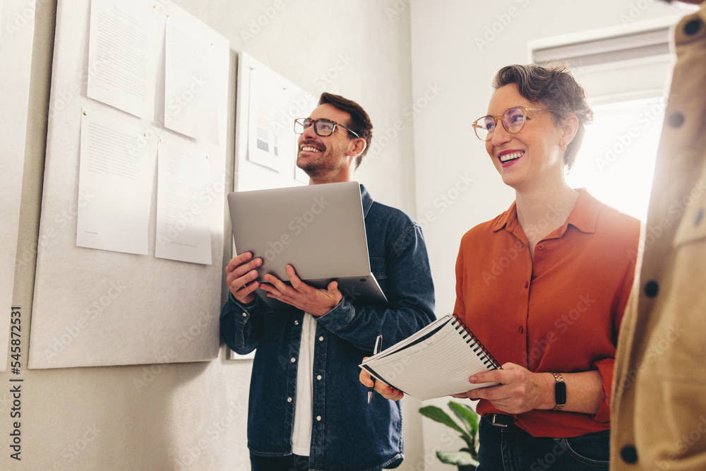 Cheerful businesspeople having a meeting in a creative workplace