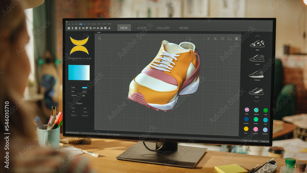 女性鞋类设计师创建和渲染鞋子的三维模型。在强大的台式计算机上工作