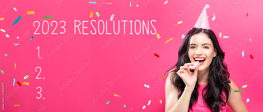 2023 Resolutions with young woman with party theme on a pink background