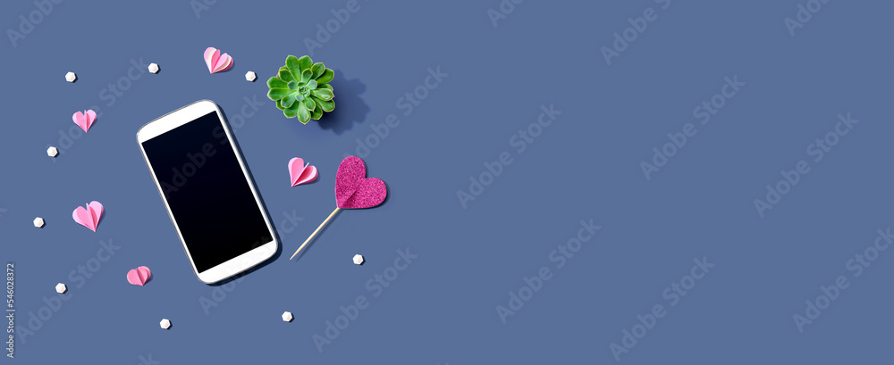 Smartphone with hearts and a succulent - flat lay