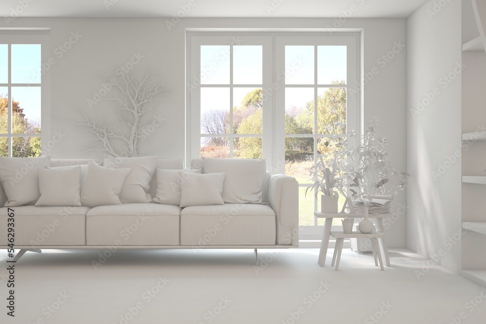 Stylish room in white color with sofa and autumn landscape in window. Scandinavian interior design. 