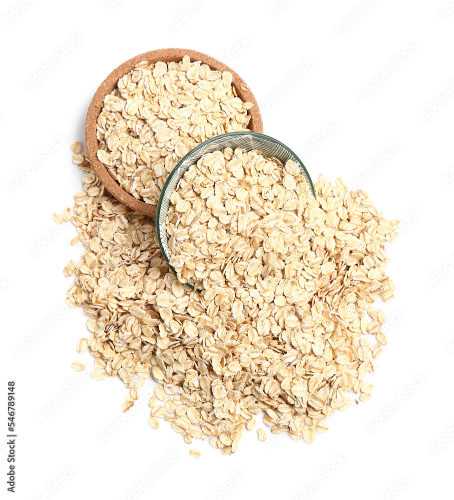 Plate and bowl with raw oatmeal on white background