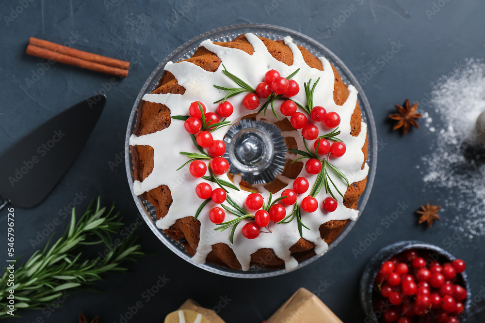 Dessert stand with traditional Christmas cake on dark background