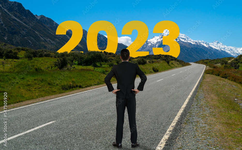 The 2023 New Year journey and future vision concept . Businessman traveling on highway road leading 