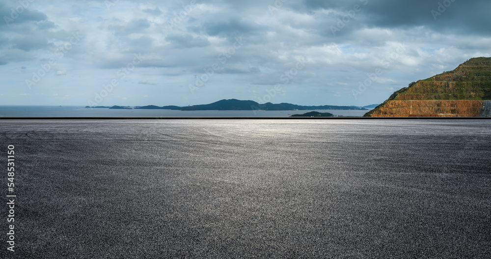 Asphalt road and mountain with sea natural landscape on a cloudy day