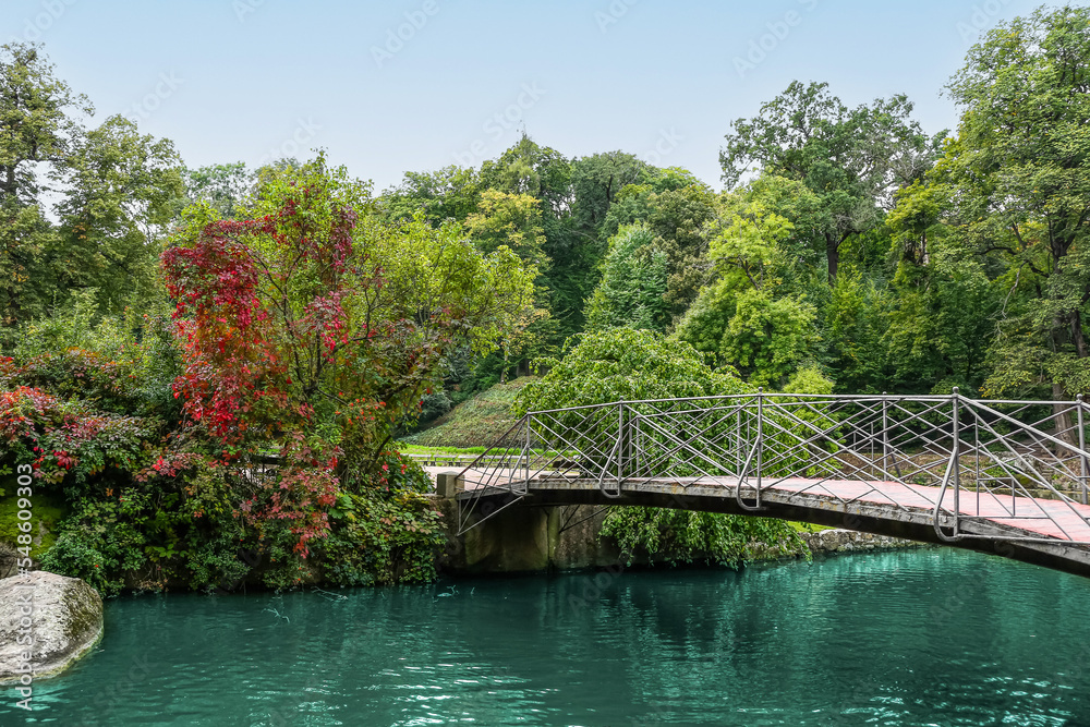 View of beautiful river with bridge and green trees