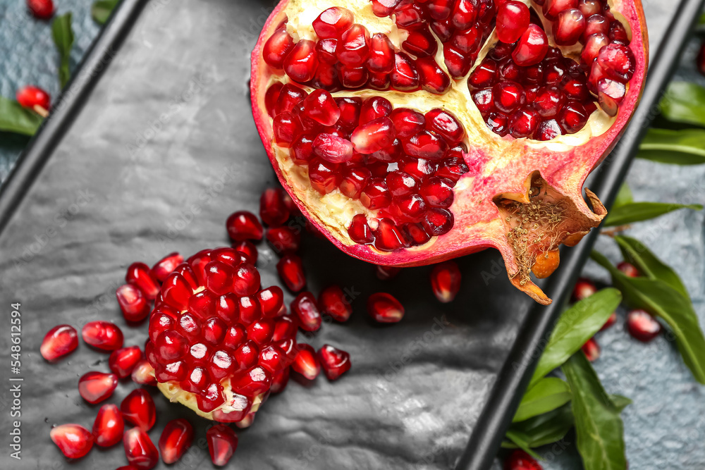 Board with fresh pomegranate, closeup