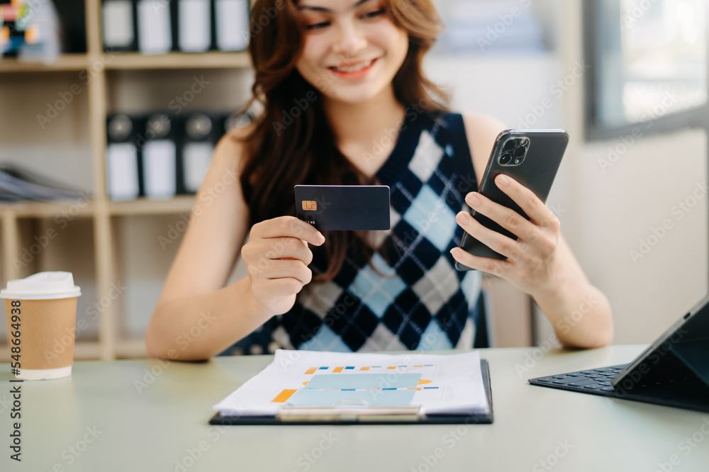 businesswoman hand using smart phone, tablet payments and holding credit card online shopping, omni 