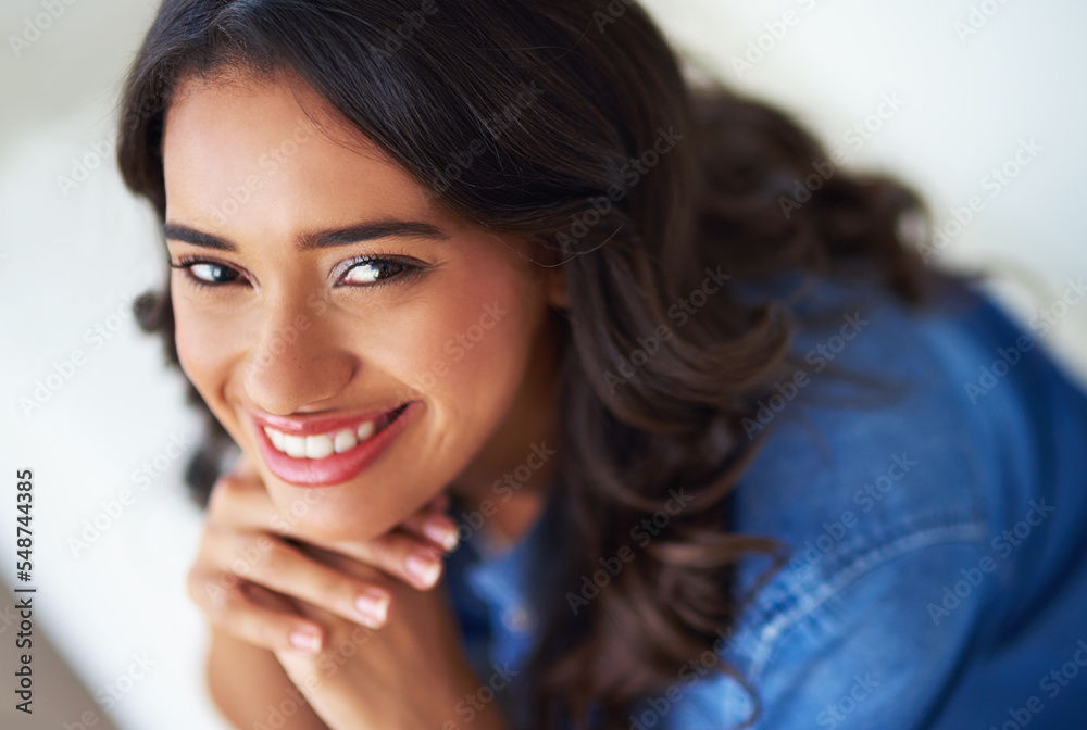 Woman, face and happy to relax portrait on sofa in home for happiness or relaxing lifestyle. Young p