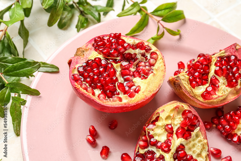 Plate with fresh pomegranates, closeup