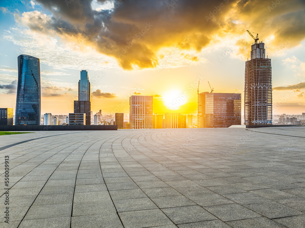 Empty square floors and modern city skyline with buildings at sunset in Ningbo, Zhejiang Province, C