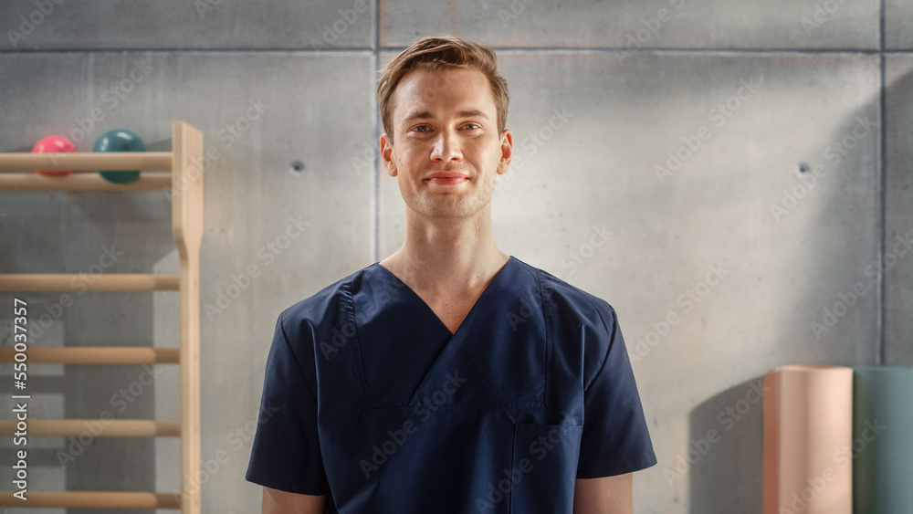 Portrait of a Handsome Professional Male Nurse in Uniform Standing and Posing for Camera, Smiling in