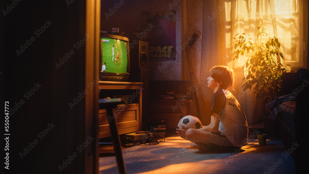 Young Sports Fan Watches a Soccer Match on TV at Home. Curious Boy Supporting His Favorite Football 