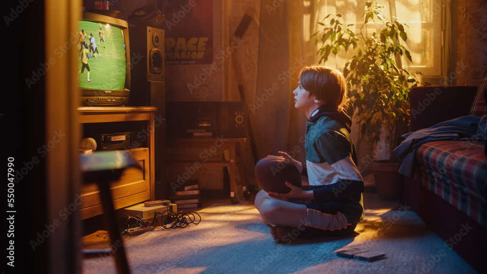 Young Sports Fan Watches American Football Match on TV at Home. Curious Boy Supporting His Favorite 