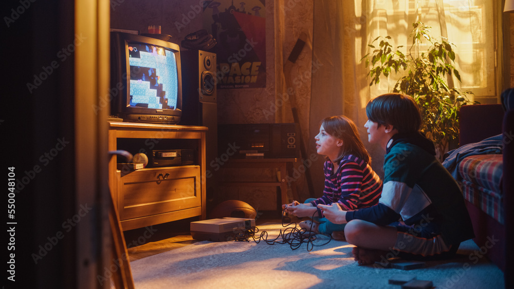 Nostalgic and Happy Childhood Concept: Young Brother and Sister Playing 8 Bit 2D Arcade Video Game o