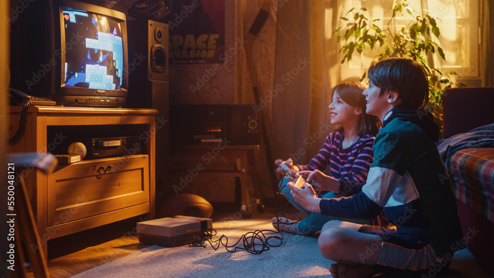 Nostalgic Childhood Concept. Young Brother and Sister Playing Old-School Arcade Video Game on Retro 