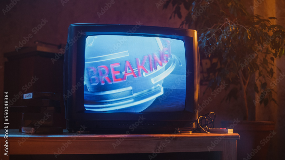 Close Up Footage of a Dated TV Set Screen: Breaking News Report. Intro with Word Breaking Revolving 