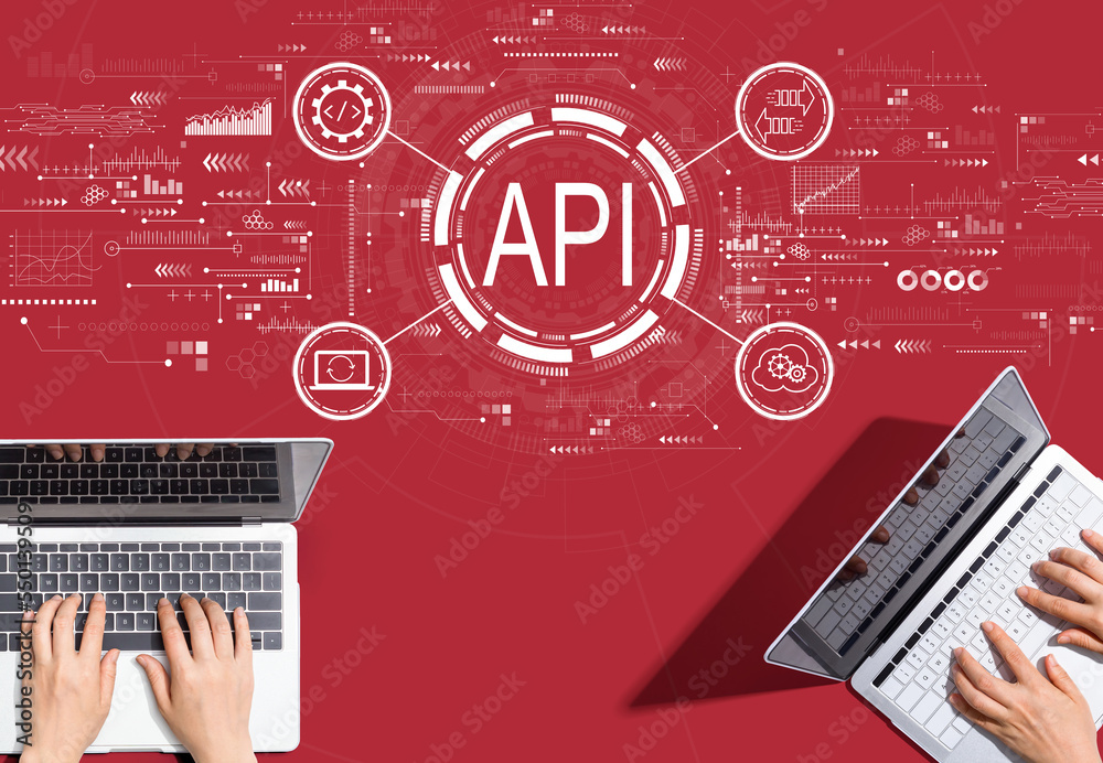 API - application programming interface concept with people working together with laptop computers