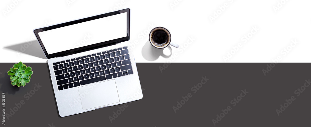 Laptop computer with a coffee cup from above