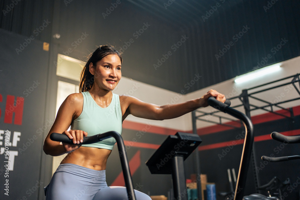 Asian young beautiful sportswoman athlete exercise in fitness stadium.