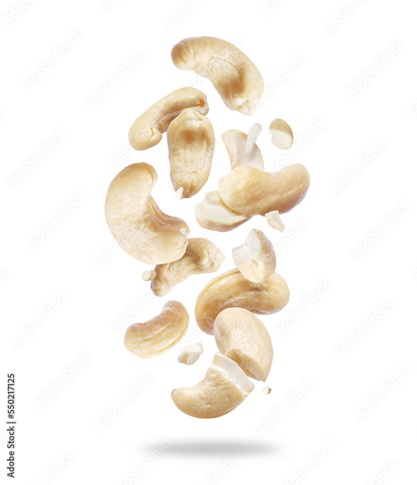 Whole and crushed cashew nuts close-up in the air on a white background